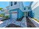 The property features light blue siding, a brick paver driveway, and manicured landscaping at 317 Via Tuscany Ave, Sarasota, FL 34243