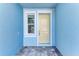 Close-up of the home's front entry with a yellow door and stone walkway at 317 Via Tuscany Ave, Sarasota, FL 34243