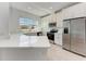 Modern kitchen featuring white cabinets, stainless steel appliances, and a center island with quartz countertops at 317 Via Tuscany Ave, Sarasota, FL 34243