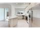 Bright, modern kitchen featuring stainless steel appliances, white cabinetry and a large quartz countertop at 317 Via Tuscany Ave, Sarasota, FL 34243