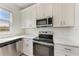 Kitchen features stainless steel appliances, quartz countertops and bright natural light at 317 Via Tuscany Ave, Sarasota, FL 34243