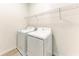 Efficient laundry room with a side-by-side washer and dryer, plus ample storage space at 317 Via Tuscany Ave, Sarasota, FL 34243