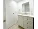 Bright bathroom features a white vanity with drawers and a mirrored wall cabinet at 3222 Sycamore Ter, Sarasota, FL 34237