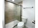Bathroom showcasing a tiled shower with a glass door and a modern toilet at 3222 Sycamore Ter, Sarasota, FL 34237