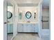 Bright bathroom featuring three mirrors over a sink and a walk-in shower at 3222 Sycamore Ter, Sarasota, FL 34237
