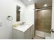 Modern bathroom featuring a vanity with white countertop and a glass-enclosed tiled shower at 3222 Sycamore Ter, Sarasota, FL 34237