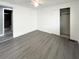 A light, airy bedroom showcases new flooring and a closet with sliding doors at 3222 Sycamore Ter, Sarasota, FL 34237