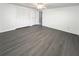 A bright bedroom boasts new gray flooring and a closet with bifold doors at 3222 Sycamore Ter, Sarasota, FL 34237