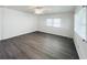A bright bedroom features new gray flooring and a ceiling fan for added comfort at 3222 Sycamore Ter, Sarasota, FL 34237
