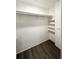 An empty closet features updated flooring and shelving for storage solutions at 3222 Sycamore Ter, Sarasota, FL 34237
