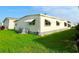 Exterior view of a home featuring awnings and landscaped grounds at 3222 Sycamore Ter, Sarasota, FL 34237