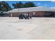 Exterior view of community building, showing golf carts parked nearby at 3222 Sycamore Ter, Sarasota, FL 34237