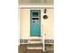 Teal front door with storm door and updated hardware at 3222 Sycamore Ter, Sarasota, FL 34237