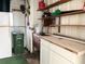 Organized garage with shelves, a workbench, and ample storage for tools and equipment at 3222 Sycamore Ter, Sarasota, FL 34237
