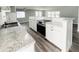 Contemporary kitchen features white cabinets, stainless steel appliances, and granite countertops at 3222 Sycamore Ter, Sarasota, FL 34237