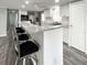Bright, open kitchen with granite countertops, white cabinetry, stainless appliances, and modern bar seating at 3222 Sycamore Ter, Sarasota, FL 34237