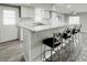 Bright kitchen features granite countertops, white cabinets, and modern bar seating on wood floors at 3222 Sycamore Ter, Sarasota, FL 34237