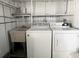 Utility space equipped with a washer, dryer and sink at 3222 Sycamore Ter, Sarasota, FL 34237