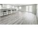 Open-concept living room featuring hardwood floors, high top seating, and natural light at 3222 Sycamore Ter, Sarasota, FL 34237