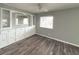Living room featuring built-in storage, grey walls, and wood floors at 3222 Sycamore Ter, Sarasota, FL 34237