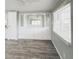 Open living room features built-in storage with light grey walls and wood floors at 3222 Sycamore Ter, Sarasota, FL 34237
