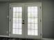 Double french doors opening onto a patio, allowing natural light to flood the room at 3222 Sycamore Ter, Sarasota, FL 34237