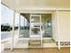 Close up of screened porch, door entrance, and outdoor table and chairs at 3222 Sycamore Ter, Sarasota, FL 34237