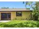 Exterior view of screened in lanai surrounded by tropical vegetation and lush green lawn at 3311 39Th W Pl, Bradenton, FL 34205