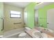 Bathroom with vanity, toilet, bathtub, window, and accessible safety bar at 3311 39Th W Pl, Bradenton, FL 34205