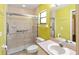 Bathroom featuring a glass door shower, safety bars, sink, toilet, and towel rack at 3311 39Th W Pl, Bradenton, FL 34205