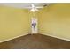 A simple bedroom featuring carpet, a ceiling fan, and access to the kitchen at 3311 39Th W Pl, Bradenton, FL 34205