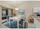 Dining room features a table set for six and sliding glass doors to the lanai at 3311 39Th W Pl, Bradenton, FL 34205