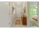 Hallway featuring tiled flooring, a wooden cabinet, and decorative wall art at 3311 39Th W Pl, Bradenton, FL 34205