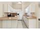 Kitchen featuring white cabinets and appliances with ample countertop space at 3311 39Th W Pl, Bradenton, FL 34205