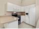 Bright kitchen featuring white cabinetry, appliances, and ample counter space at 3311 39Th W Pl, Bradenton, FL 34205