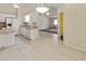 Open kitchen area with white cabinets and access to the living room at 3311 39Th W Pl, Bradenton, FL 34205