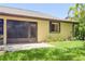 Exterior of the home featuring a screened lanai and meticulously maintained yard with tropical plants at 3311 39Th W Pl, Bradenton, FL 34205