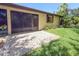 Exterior of the home featuring a screened lanai and meticulously maintained yard with tropical plants at 3311 39Th W Pl, Bradenton, FL 34205