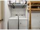 Clean laundry room with washer, dryer and shelving at 3311 39Th W Pl, Bradenton, FL 34205