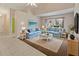 Living room with tile flooring, plush blue sofas, and large windows at 3311 39Th W Pl, Bradenton, FL 34205