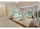 Living room with tile flooring, plush white sofas, and large windows at 3311 39Th W Pl, Bradenton, FL 34205