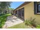 Exterior view of screened lanai with lush lawn featuring tropical plants and patio at 3311 39Th W Pl, Bradenton, FL 34205