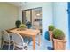 Covered patio with a dining table and view into the kitchen at 3311 39Th W Pl, Bradenton, FL 34205