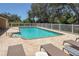 In-ground pool surrounded by a white fence and lounge chairs at 3311 39Th W Pl, Bradenton, FL 34205