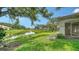 Beautiful backyard view of the pond from the home's exterior with mature trees at 3317 Highlands Bridge Rd # 61, Sarasota, FL 34235