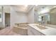 Bathroom featuring a soaking tub, mirrored vanity, and tile flooring at 3317 Highlands Bridge Rd # 61, Sarasota, FL 34235
