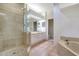 Spacious bathroom with a glass-enclosed shower, double vanity, and soaking tub at 3317 Highlands Bridge Rd # 61, Sarasota, FL 34235
