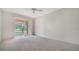 Bright bedroom with sliding glass doors to the porch, ceiling fan, and neutral carpet at 3317 Highlands Bridge Rd # 61, Sarasota, FL 34235