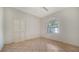 Bedroom with tile flooring, arched window, and closet at 3317 Highlands Bridge Rd # 61, Sarasota, FL 34235
