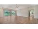 Large living room with tile floors, sliding glass doors, and a view of the pond at 3317 Highlands Bridge Rd # 61, Sarasota, FL 34235